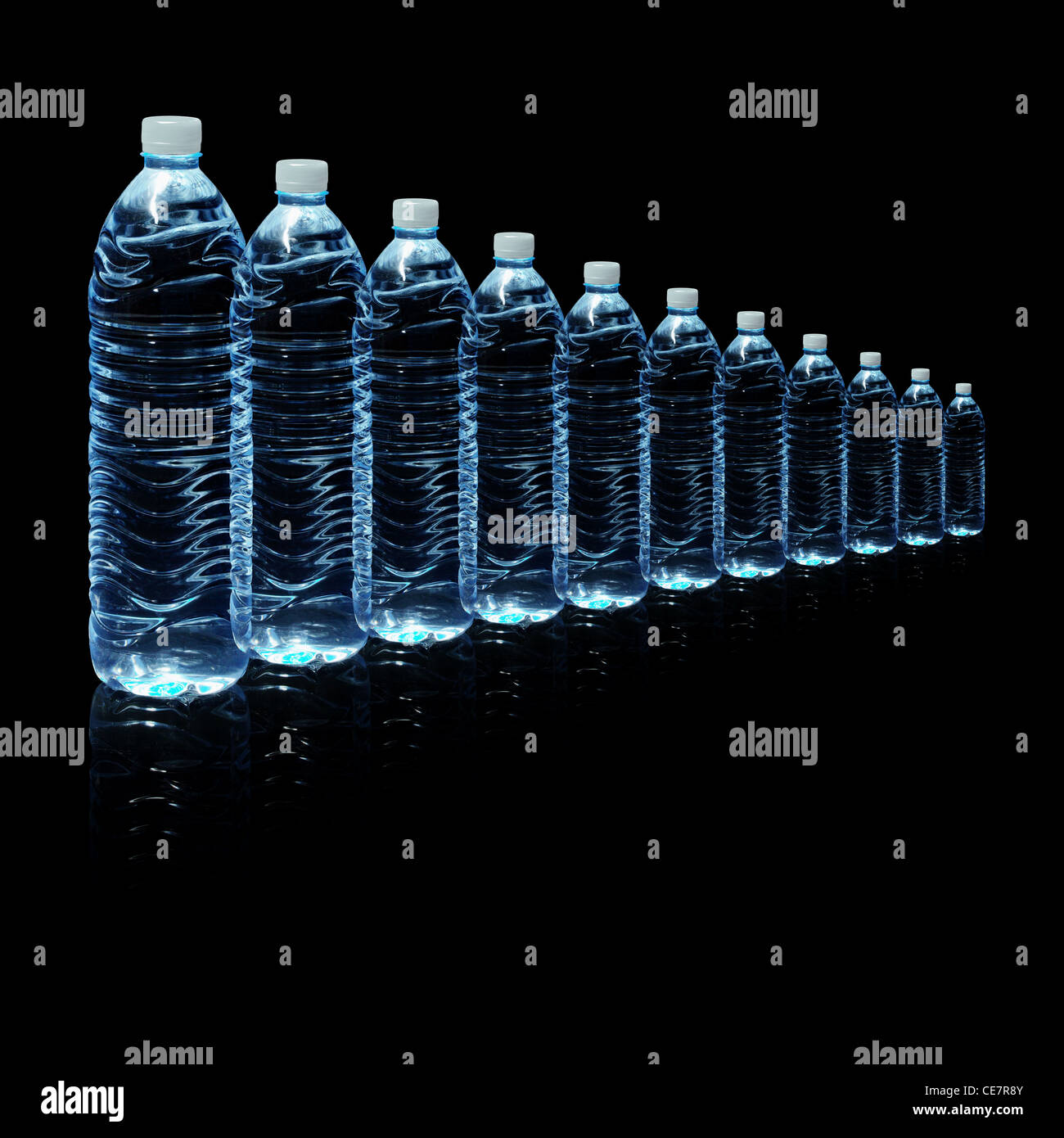 Several bottles of drinking water isolated on a black background Stock Photo