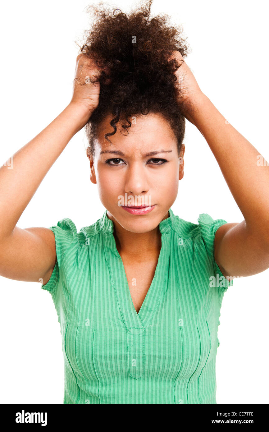 Portrait of a frustrated woman pulling her hair. Studio shot with isolated white background. Stock Photo