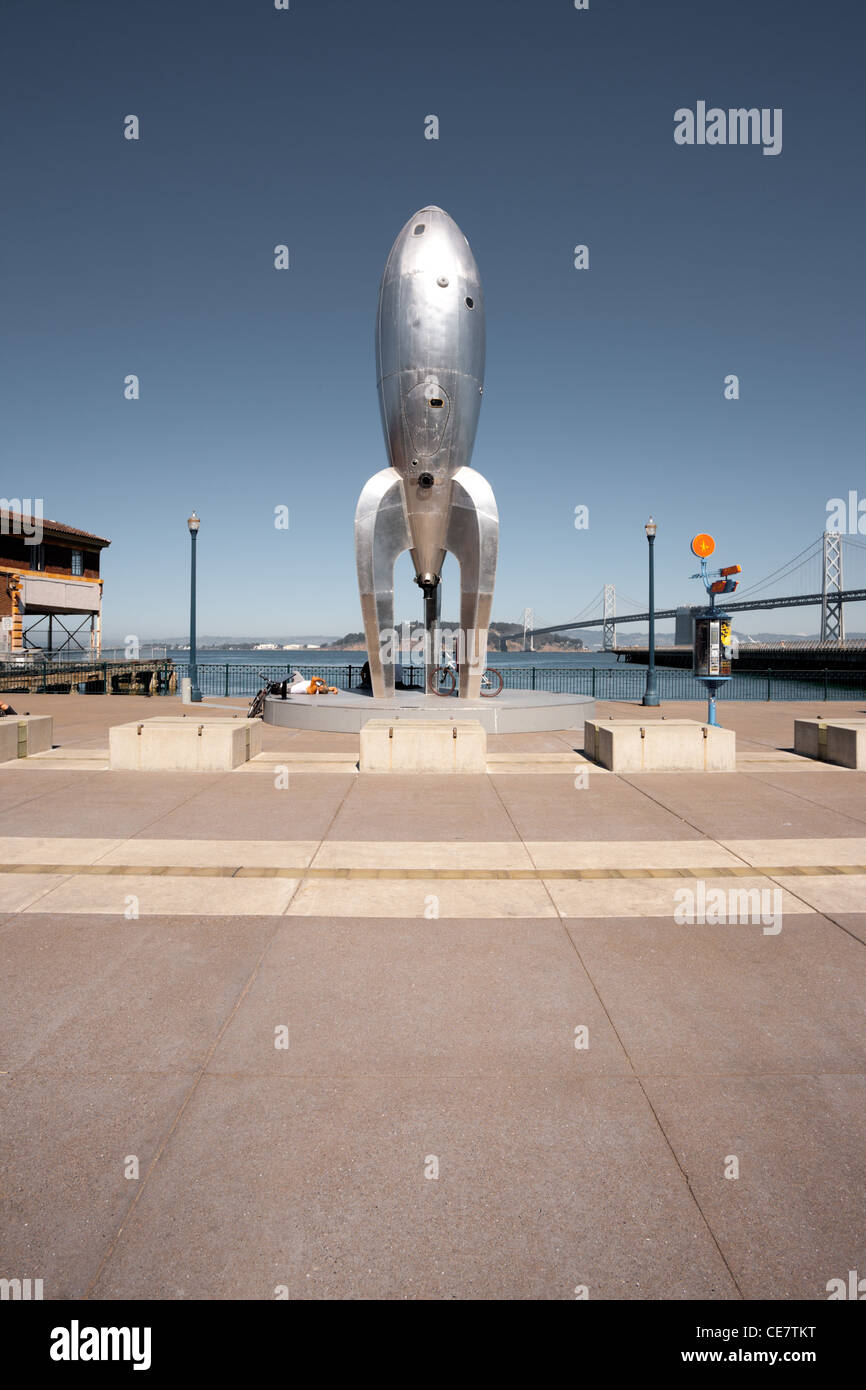 Art installation, the Raygun Gothic Rocketship stands on a busy tourist promenade along the Embarcadero and Bay Bridge Stock Photo