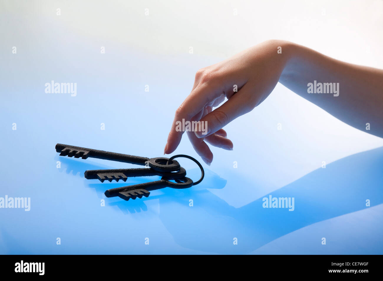 Woman's hand gently touching a bunch of retro keys Stock Photo