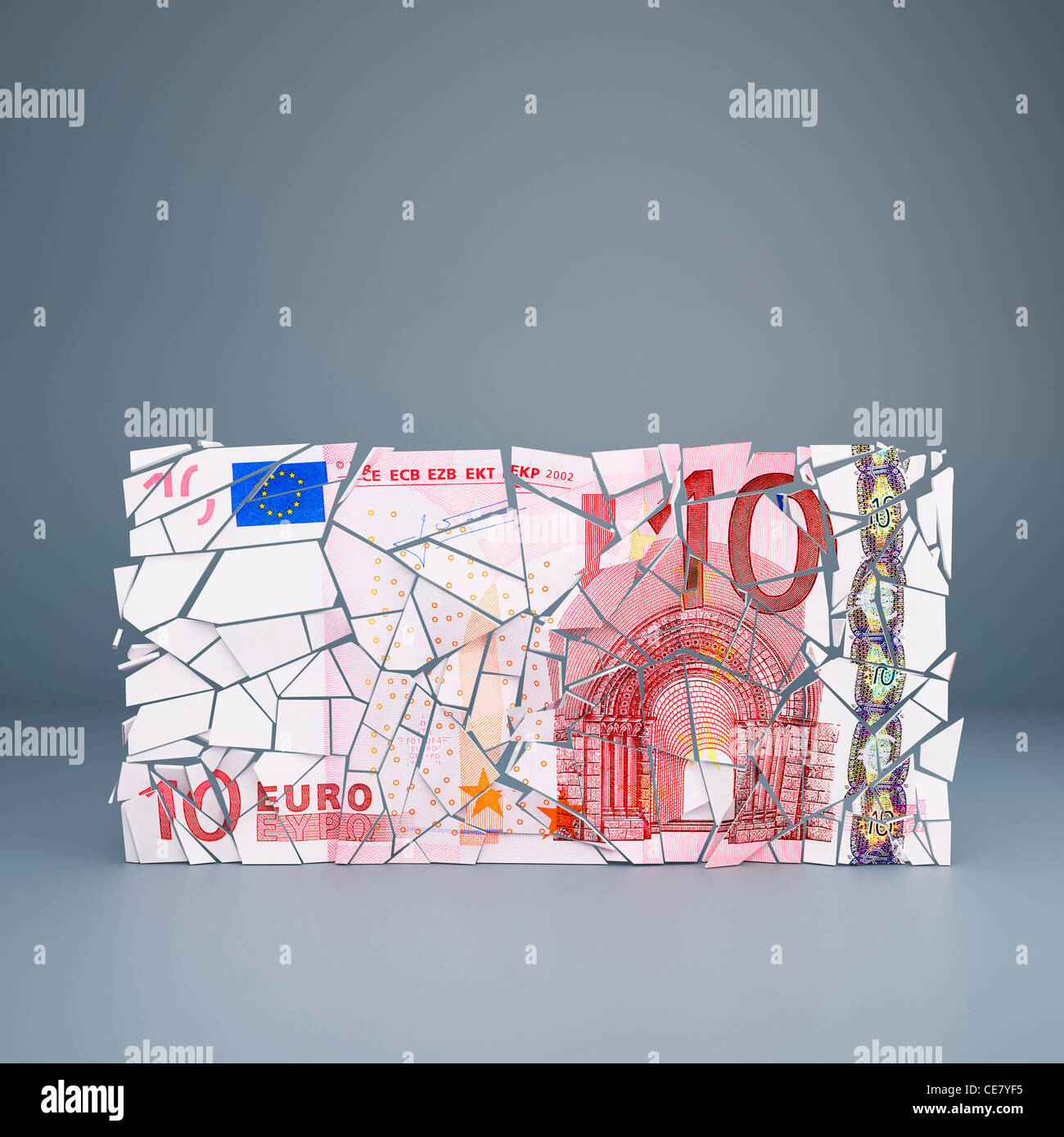 Ten Euro note crumbling - representing the break up of the European Union single currency / default of Eurozone countries Stock Photo