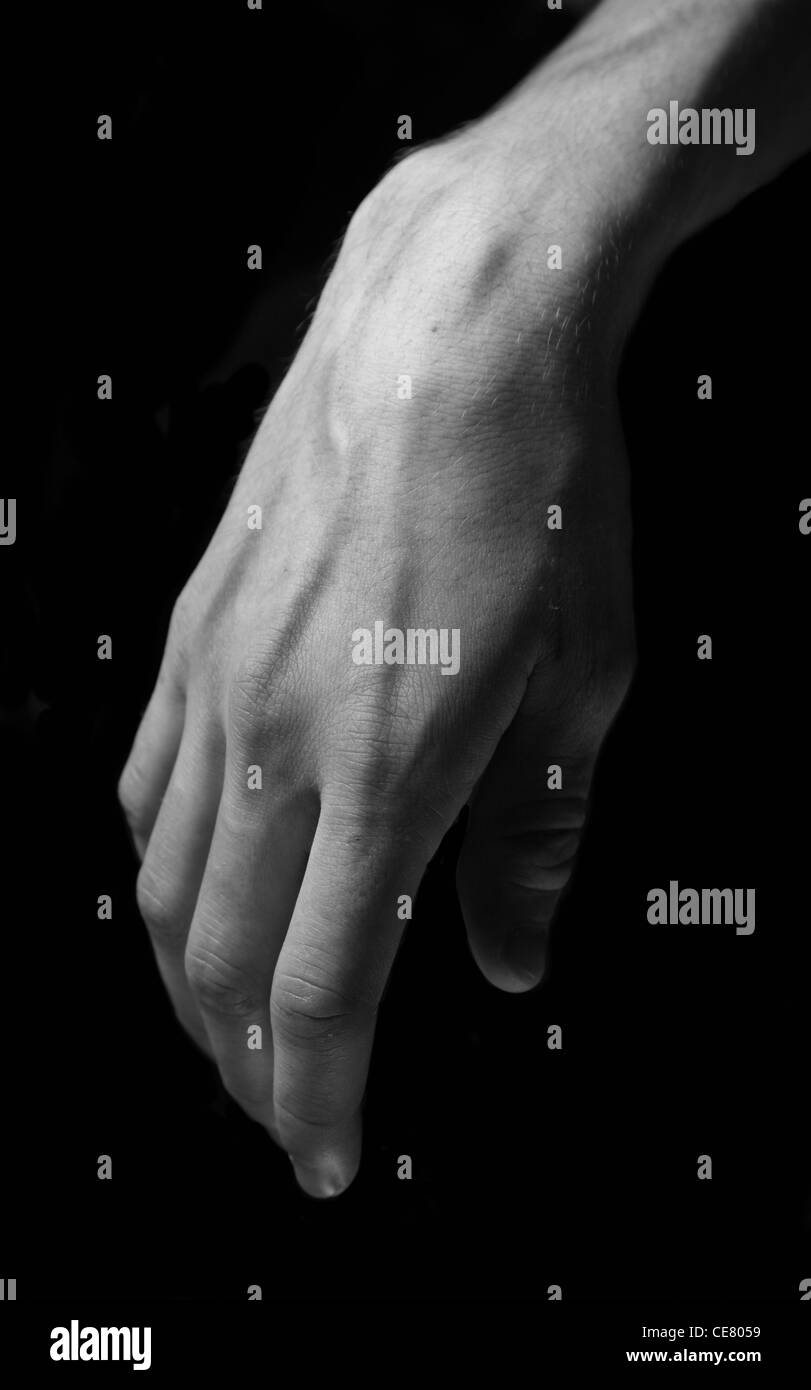 Black and white study of human hand against a black background Stock ...