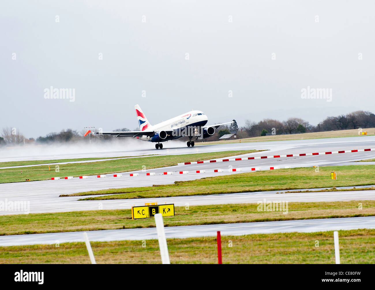British Airways Airbus A319-131 Airliner G-EUPA Taking Off From Manchester International Airport in Rain England United Kingdom Stock Photo