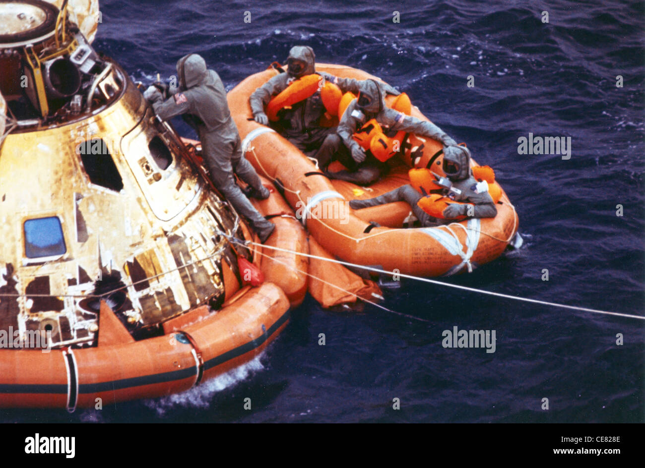 First Lt. Clancy Hatleberg closes the Apollo 11 spacecraft hatch as astronauts Neil Armstrong, Michael Collins and Buzz Aldrin, Jr. await helicopter pickup from their life raft in 1969. The command module moved from Patrick Air Force Base, Fla. for refurbishment was used by pararescuemen to train for both the Apollo and Skylab programs. The 920th Rescue Wing provides emergency medical, rescue and recovery support for all space shuttle and rocket launches. Stock Photo