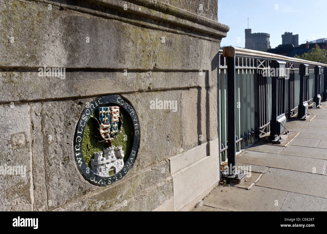 Detail of Windsor Bridge showing a plaque with the Royal Coat of Arms and a depiction of Windsor Castle (seen in the background) Stock Photo