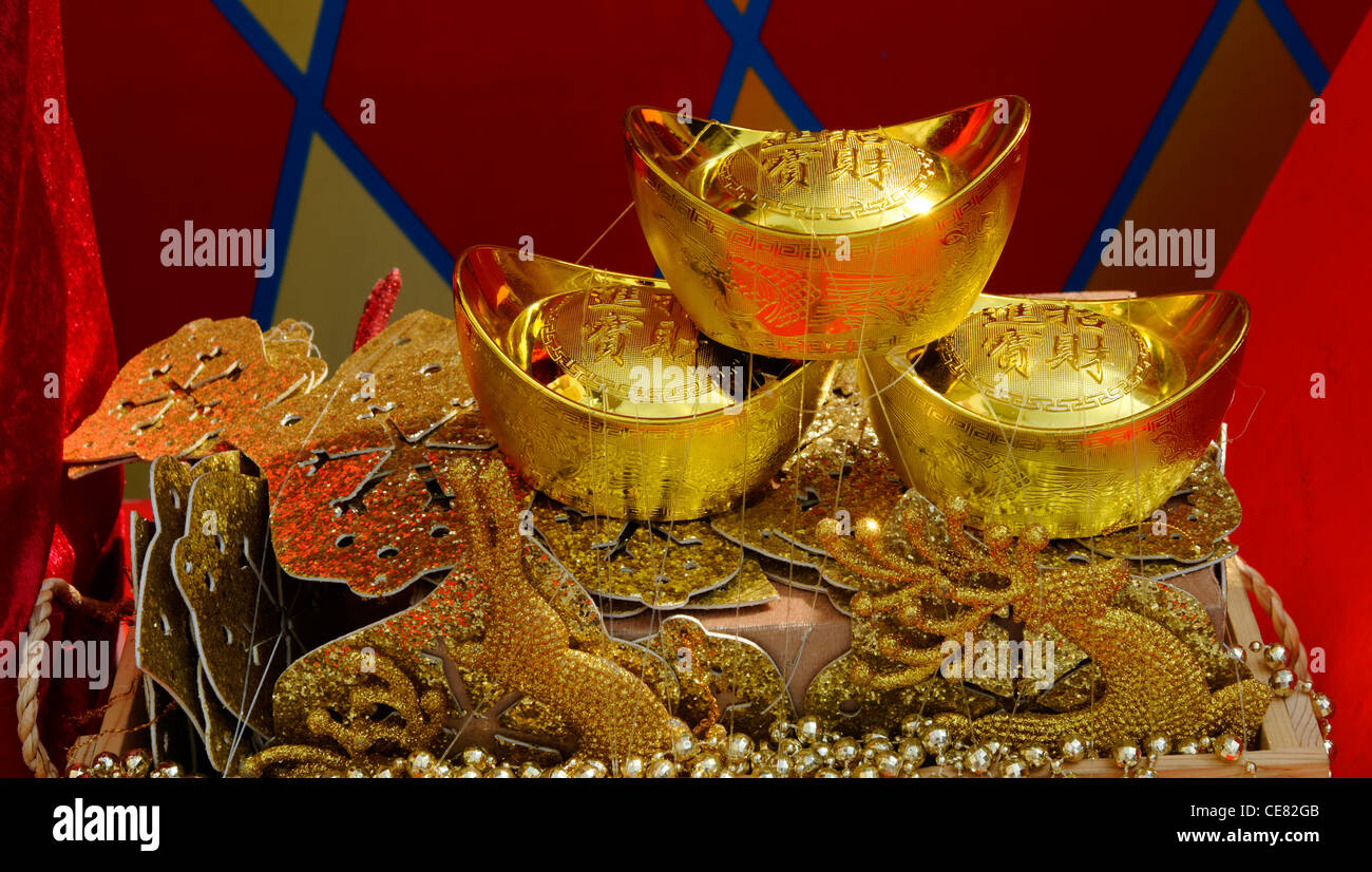 Gold Yuanbao Ingots on a table, indicating wealth, luck and fortune for Chinese New Yea Stock Photo