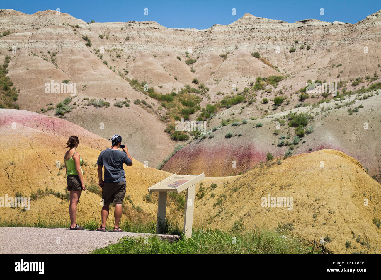 American National Park Badlands rocky mountains South Dakota SD in USA US landscape with people rear view pictures images horizontal hi-res Stock Photo