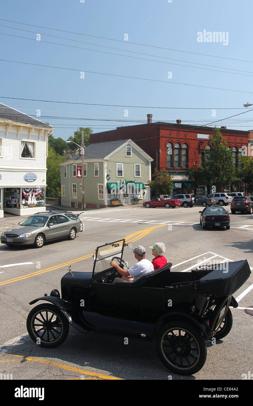 People driving an antique car in downtown Exeter, New Hampshire Stock Photo
