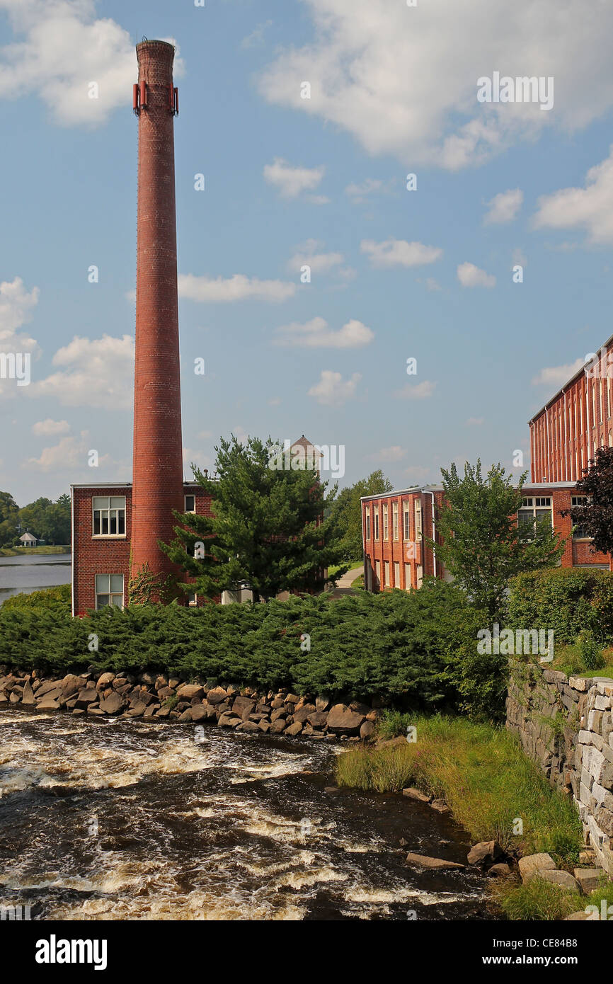 The smokestack of an old factory building on the river in Exeter, New Hampshire Stock Photo