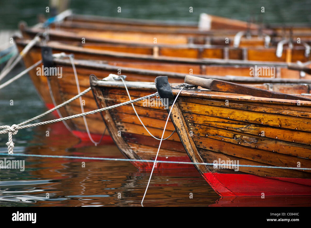 The bows of several rowing boats lined up on the dock in Bowness-on-Windermere Stock Photo