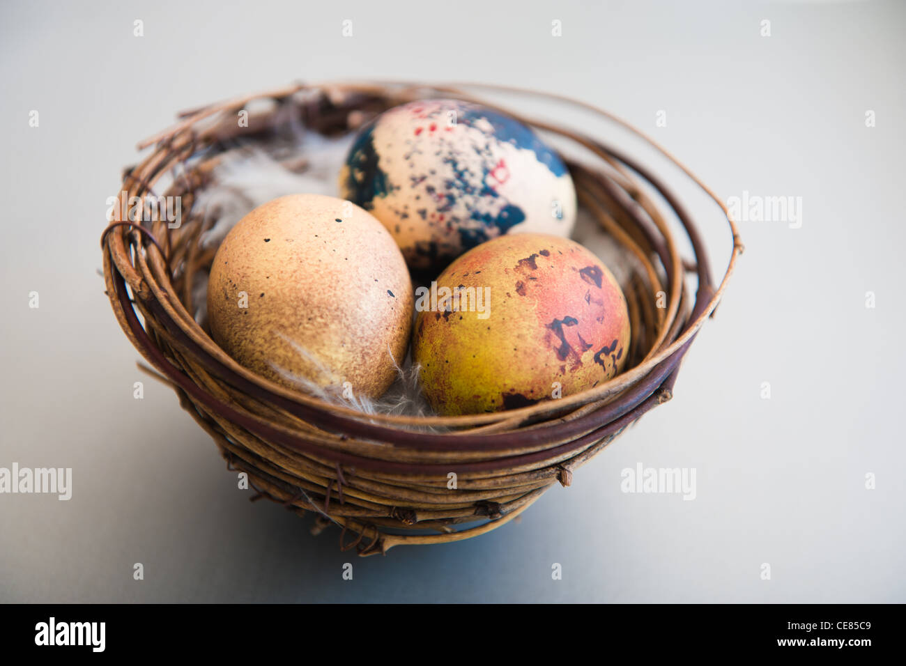 Close up of ornate quails eggs in a basket Stock Photo