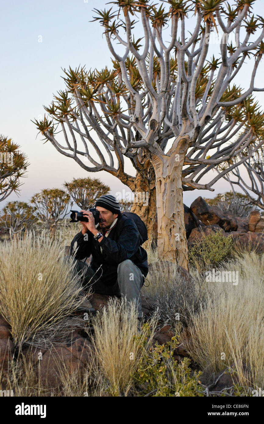 Photographer with quivertrees, Namibia Stock Photo