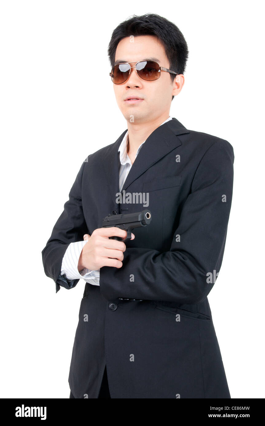 asian man holding a gun Stock Photo