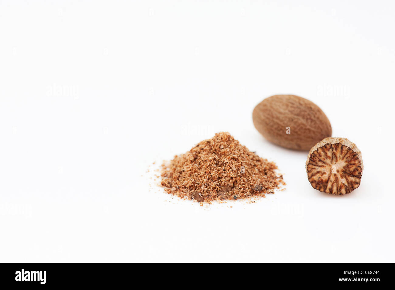 Myristica fragrans. Nutmeg and ground nutmeg on white background Stock Photo