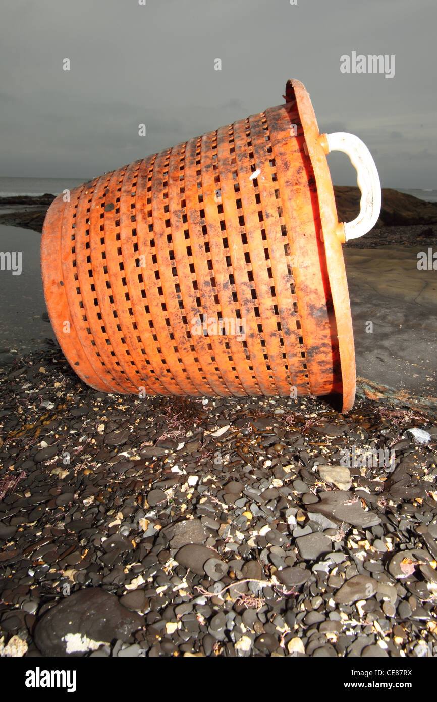 Plastic fish basket washed up on beach, Kimmeridge Dorset UK. Stock Photo