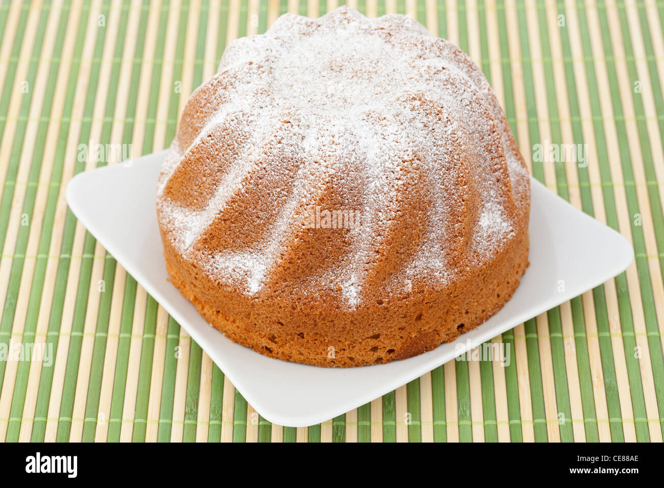 Sweet cake on white plate and mat Stock Photo