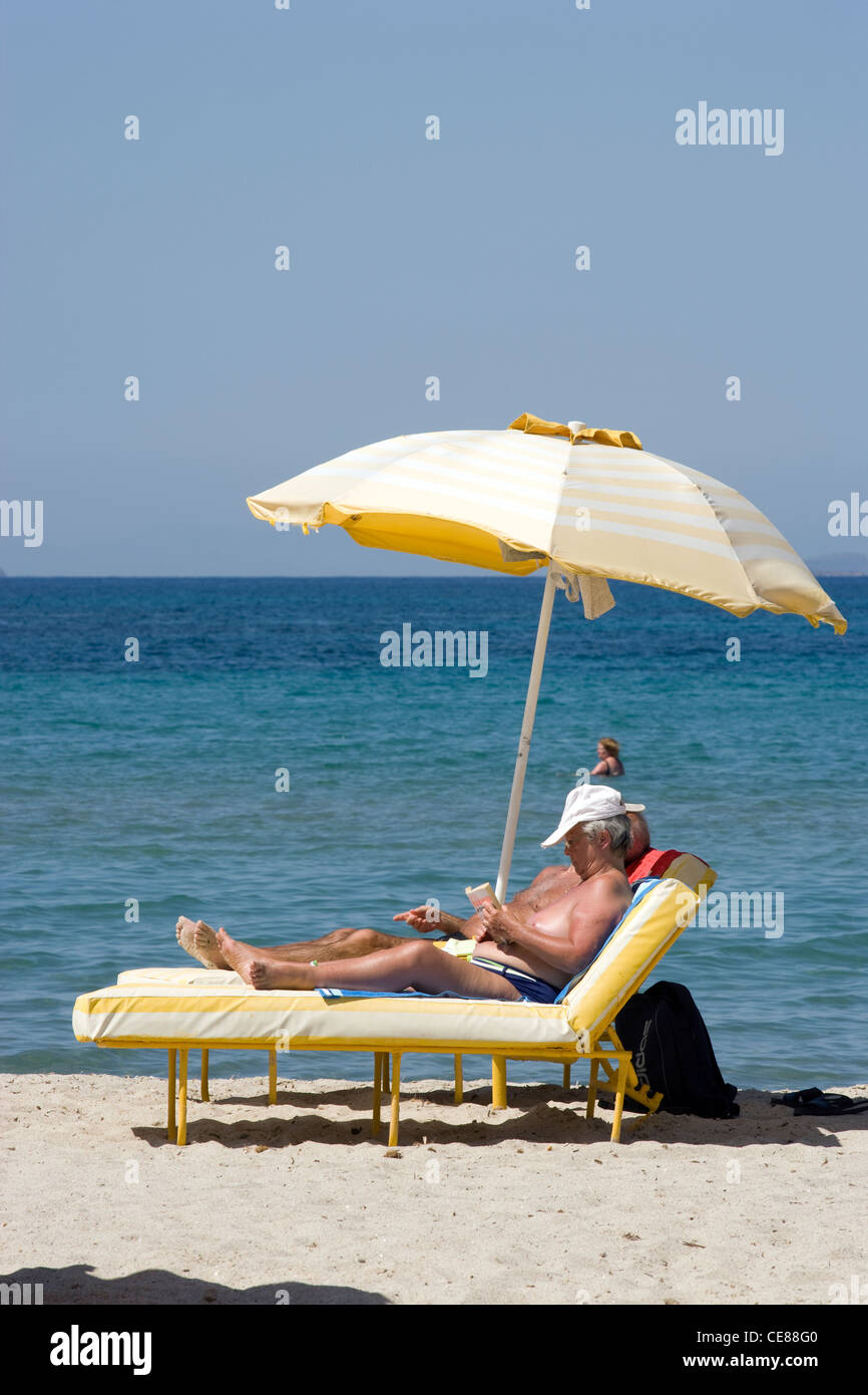 Greece Islands: sunbathing on beach Stock Photo