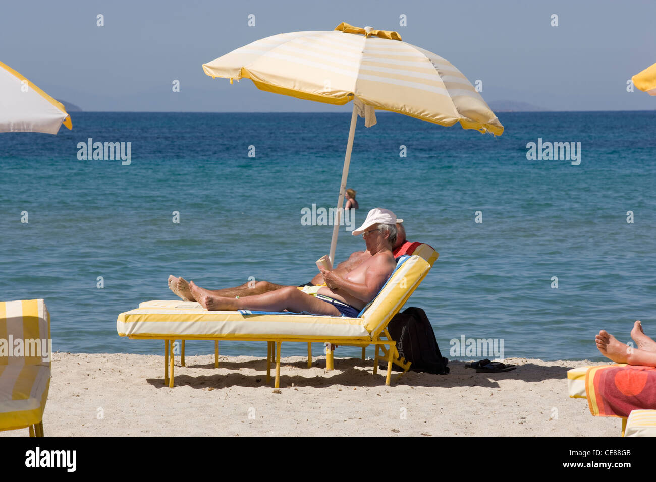 Greece Islands: sunbathing on beach Stock Photo