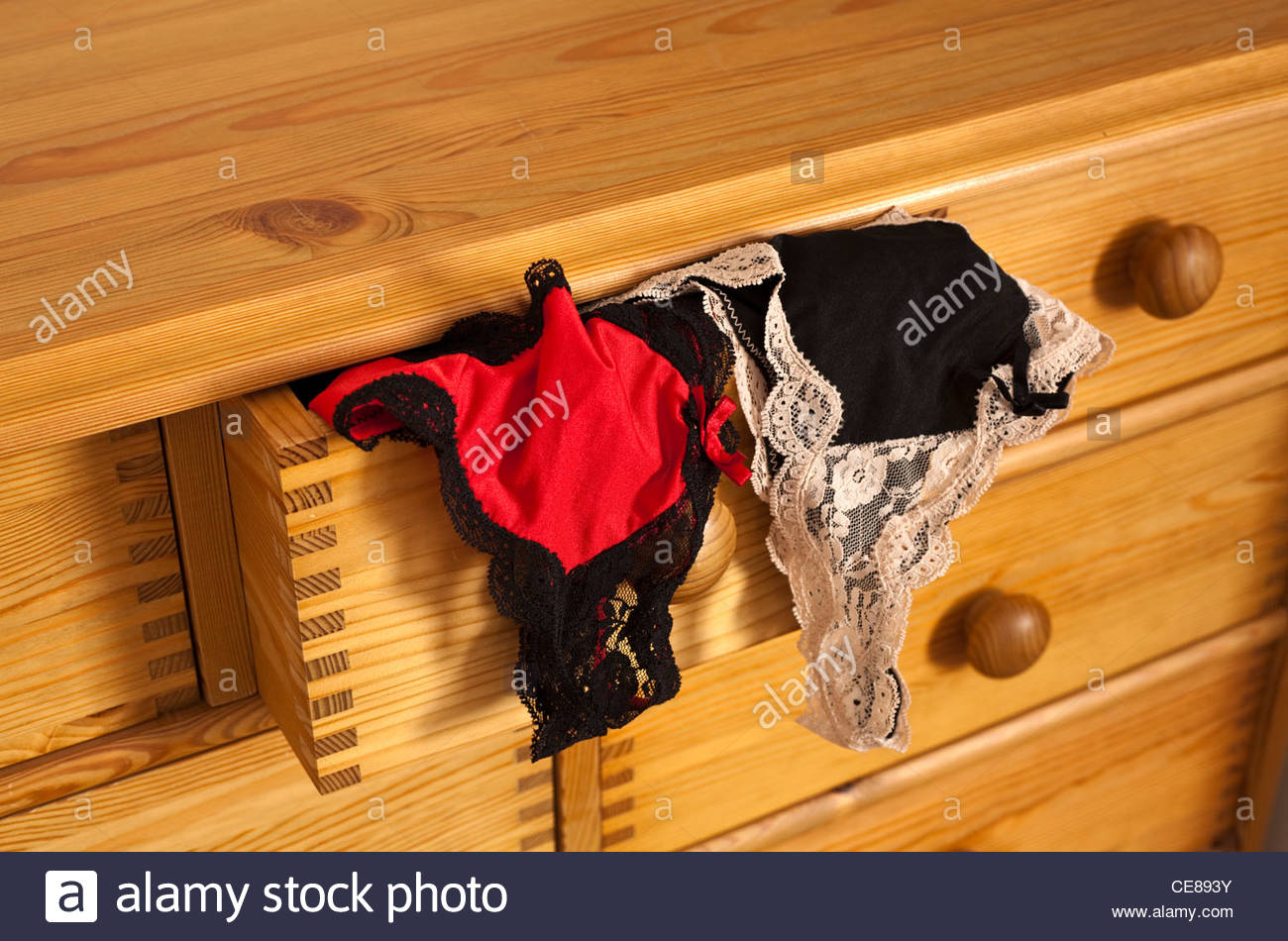 Ladies Underwear Hanging Out Of An Open Drawer Stock Photo