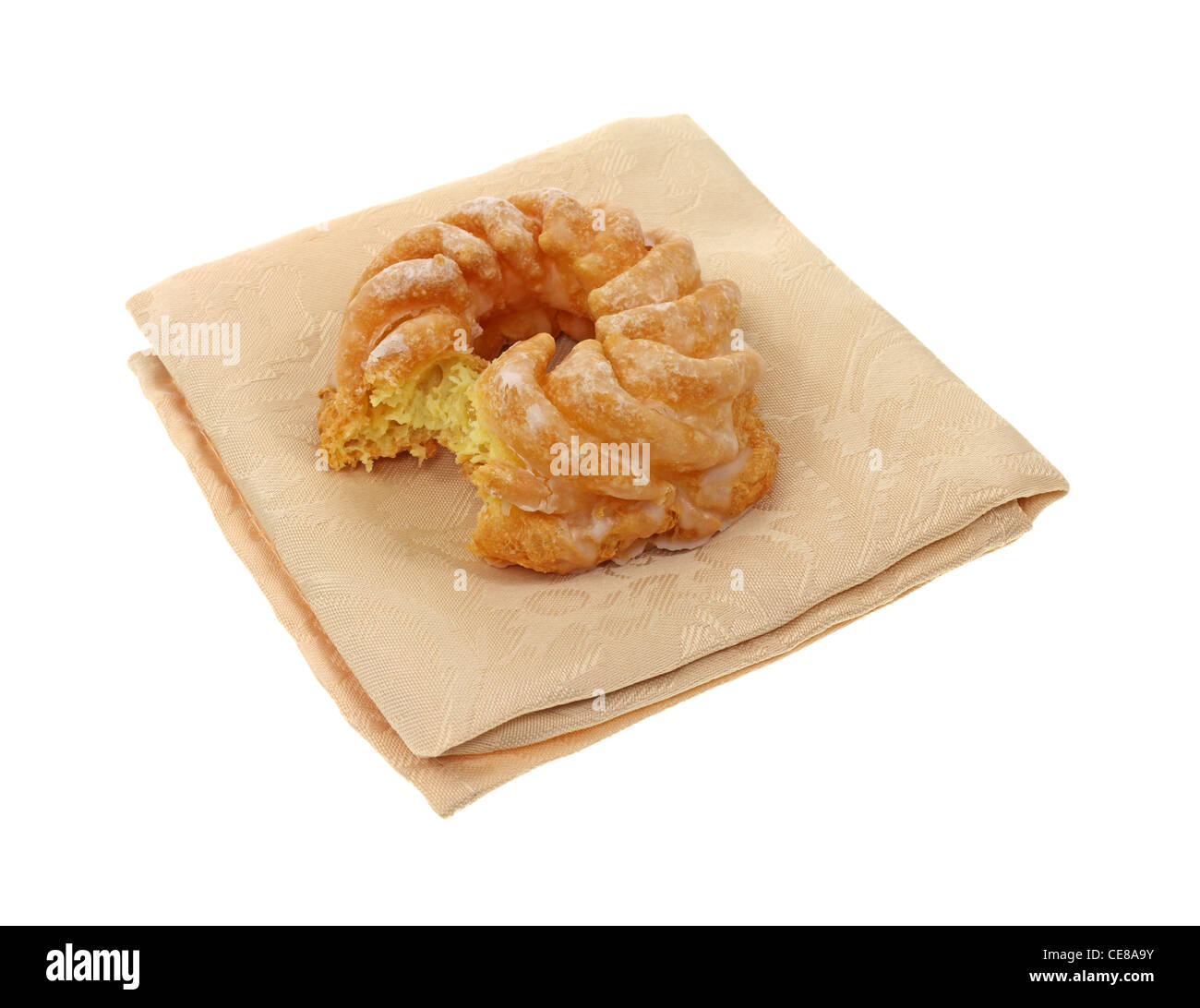 Cruller doughnut on cloth napkin bitten Stock Photo