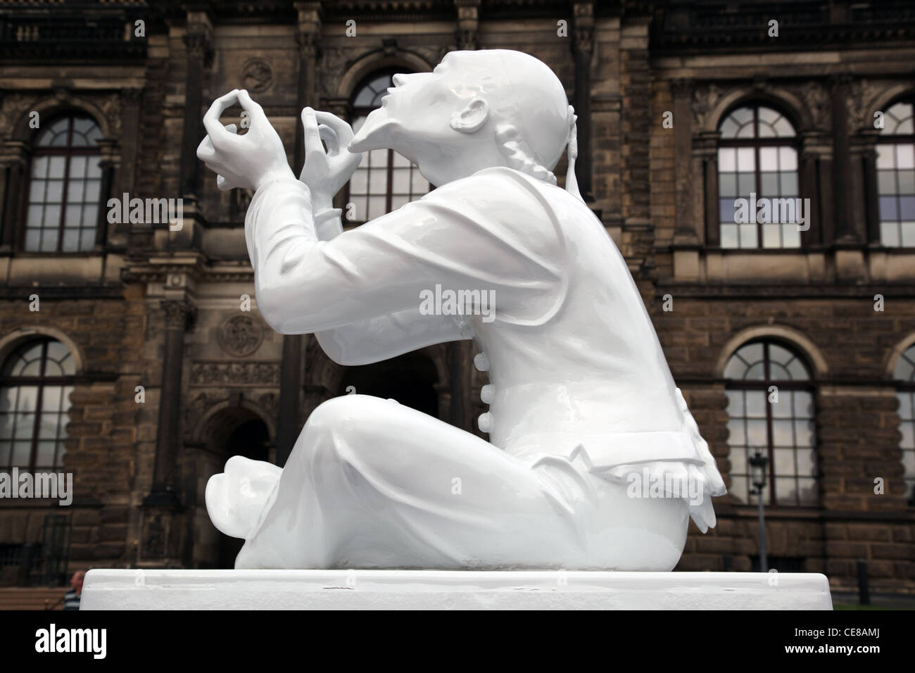 Meissen porcelain figure at the Zwinger Castle featuring trickster Tailor Wibbel threading a needle Dresden Germany Stock Photo