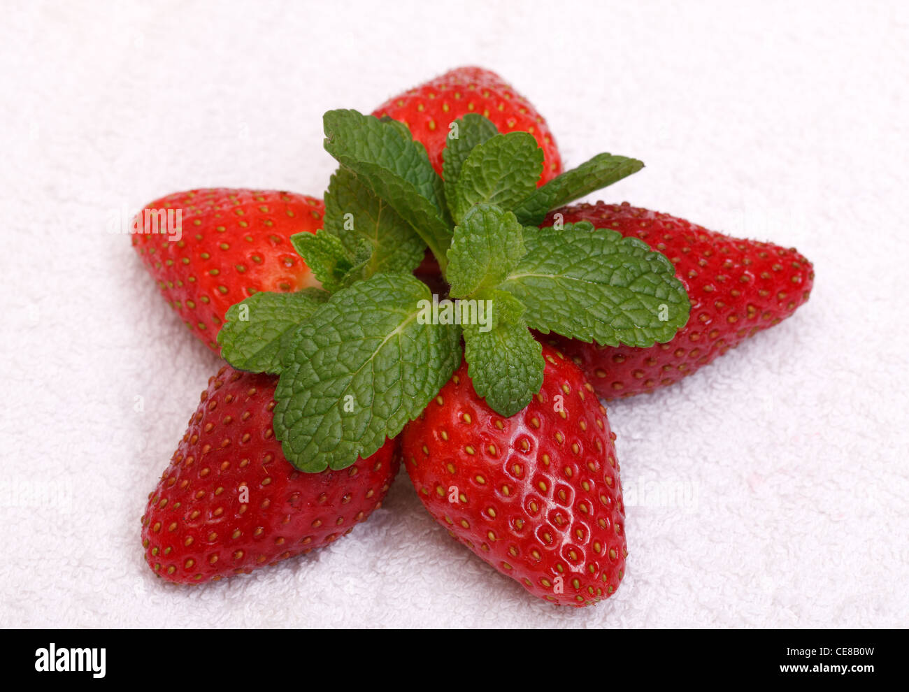 Strawberries with mint over white background Stock Photo - Alamy