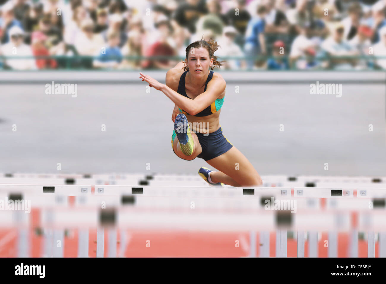 Female Runner Hurdling Stock Photo