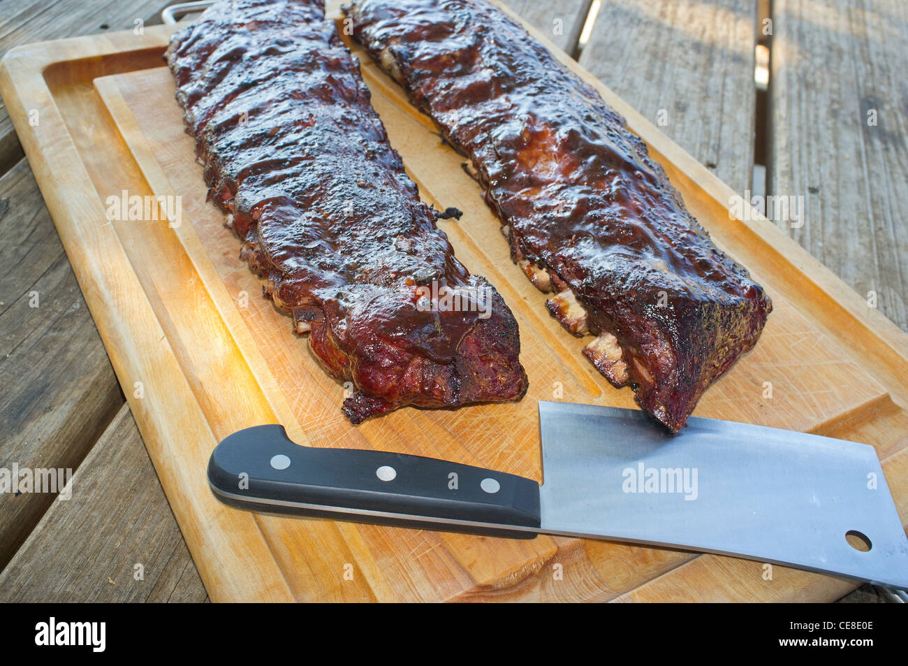 Spare ribs and meat cleaver on a cutting board Stock Photo Alamy