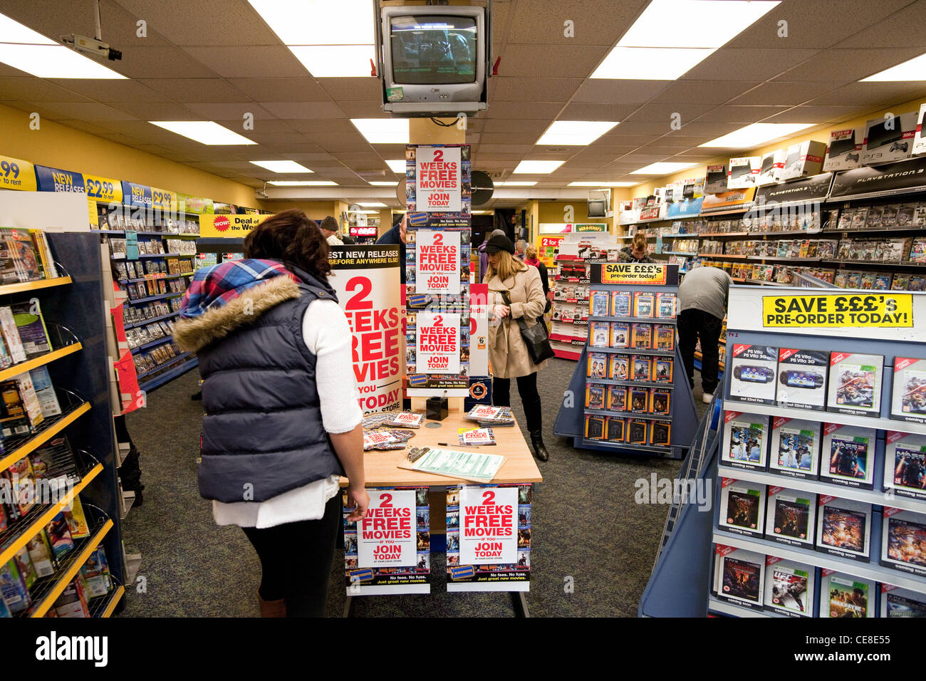 Teenage girl joining Blockbuster to rent movies, Newmarket  UK Stock Photo