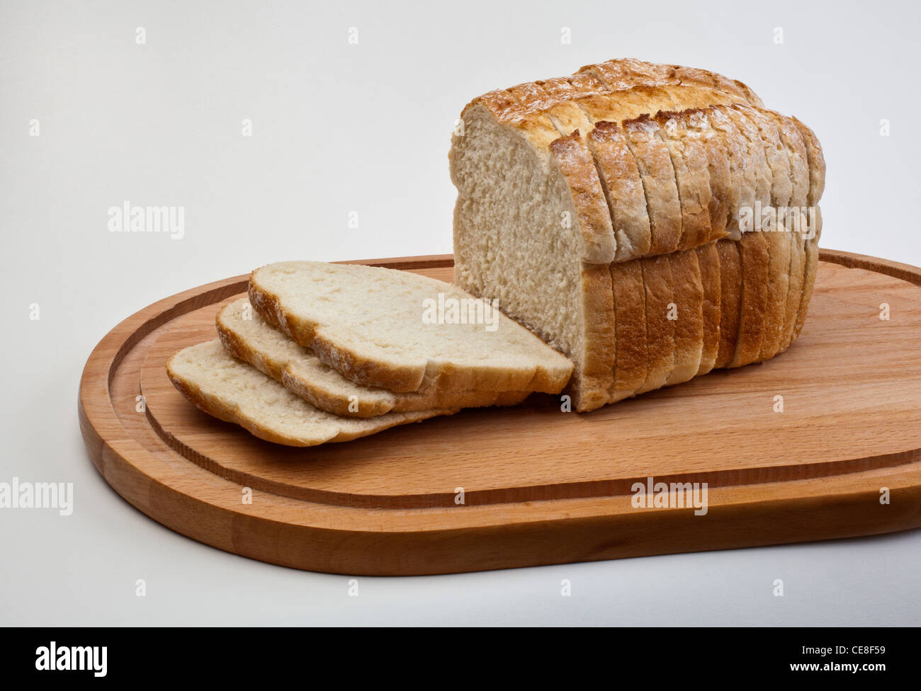 Sliced loaf of white bread on breadboard Stock Photo Alamy