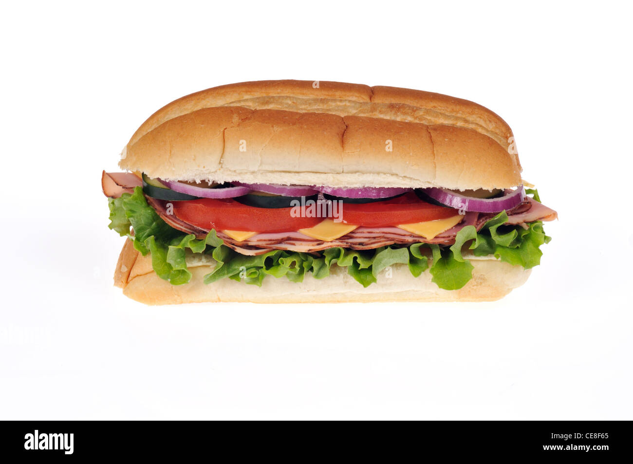 Ham and cheese salad sub sandwich with lettuce, tomatoes, onions and cucumber on white background cutout. Stock Photo
