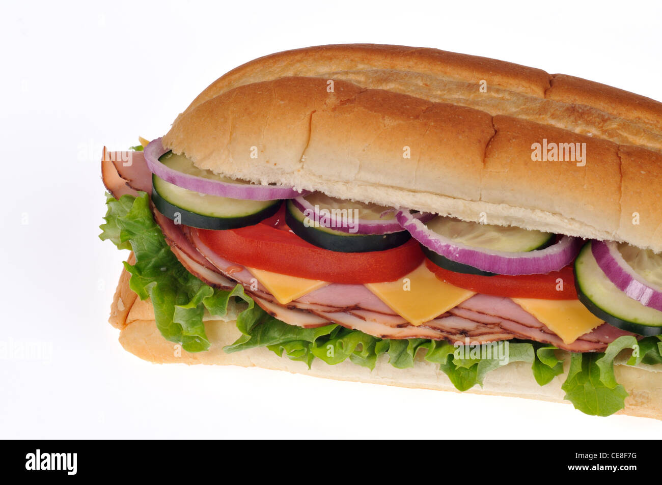 Ham salad with cheese  sandwich with lettuce, tomatoes, cucumber and red onions in a submarine roll on white background Stock Photo