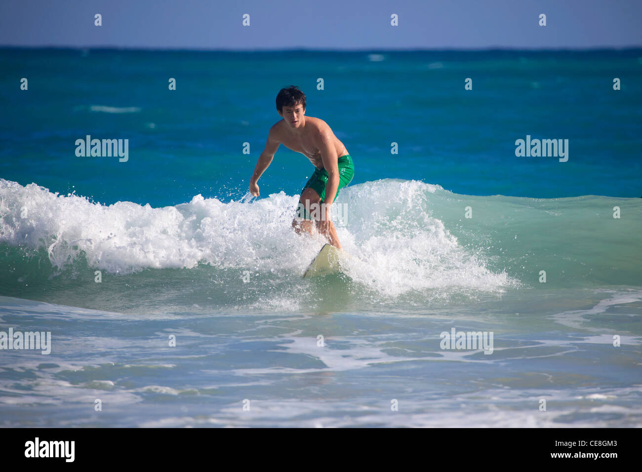 young asian american man surfing in hawaii Stock Photo