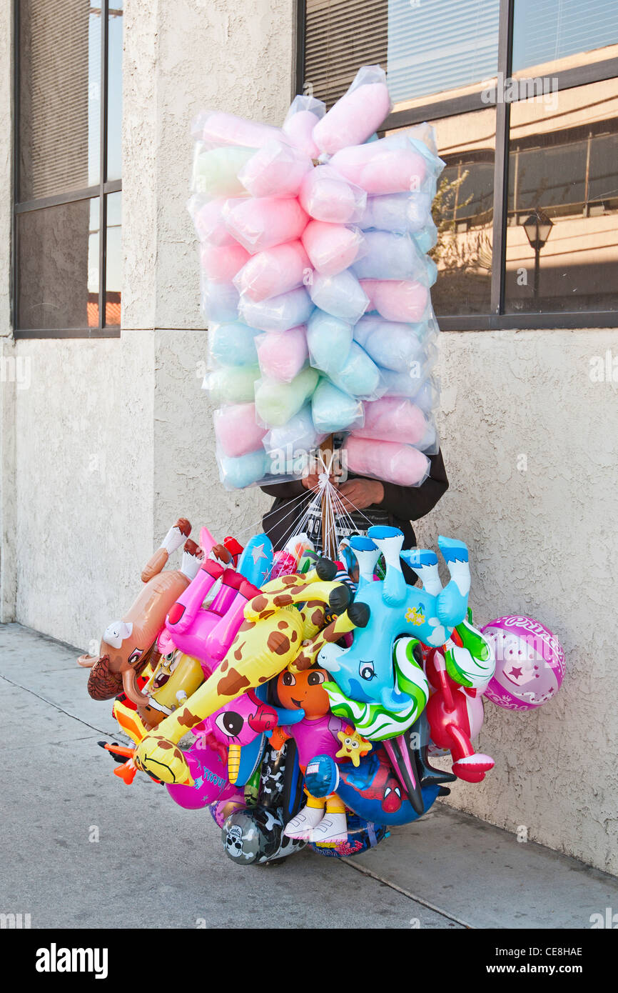 A parade vendor selling cotton candy and toys Stock Photo Alamy