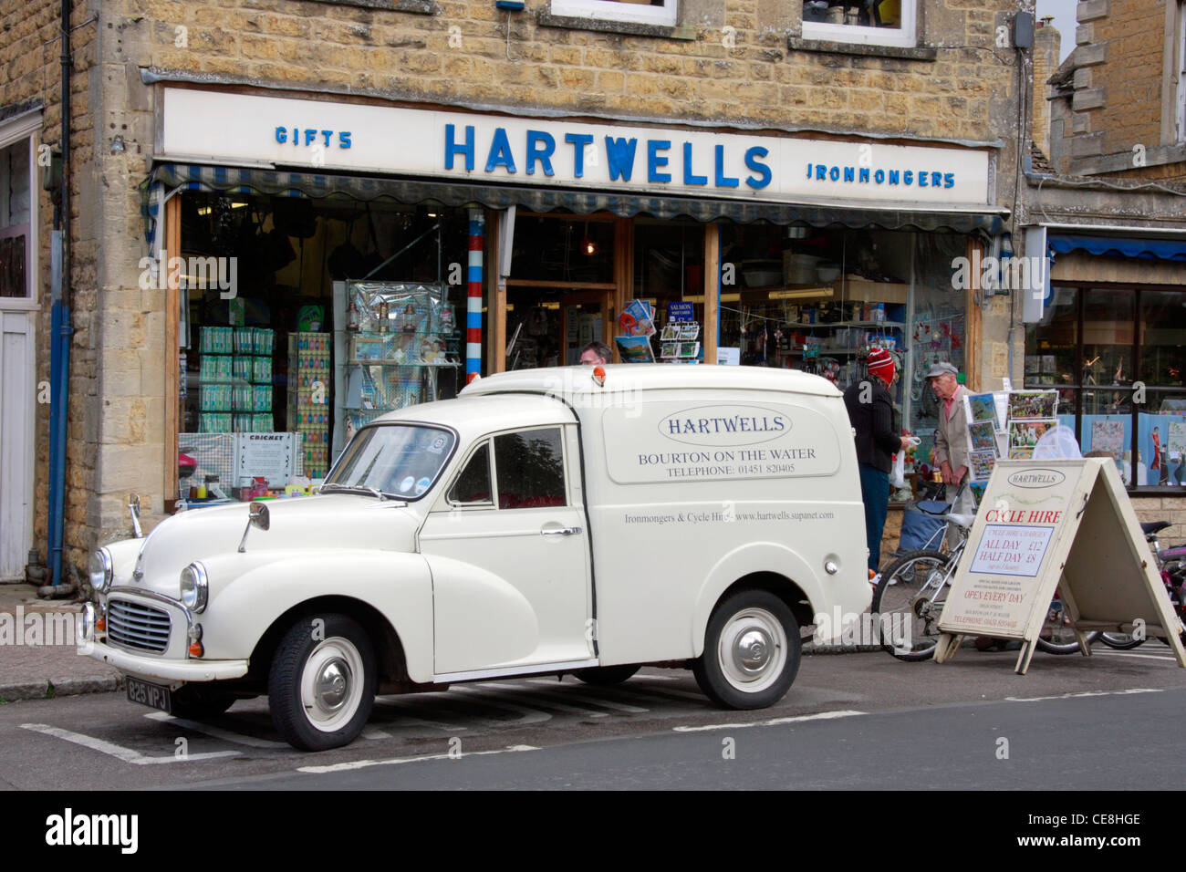 Old Morris van outside Hartwells Ironmongers shop in Bourton on the Water in the Cotswolds. Stock Photo