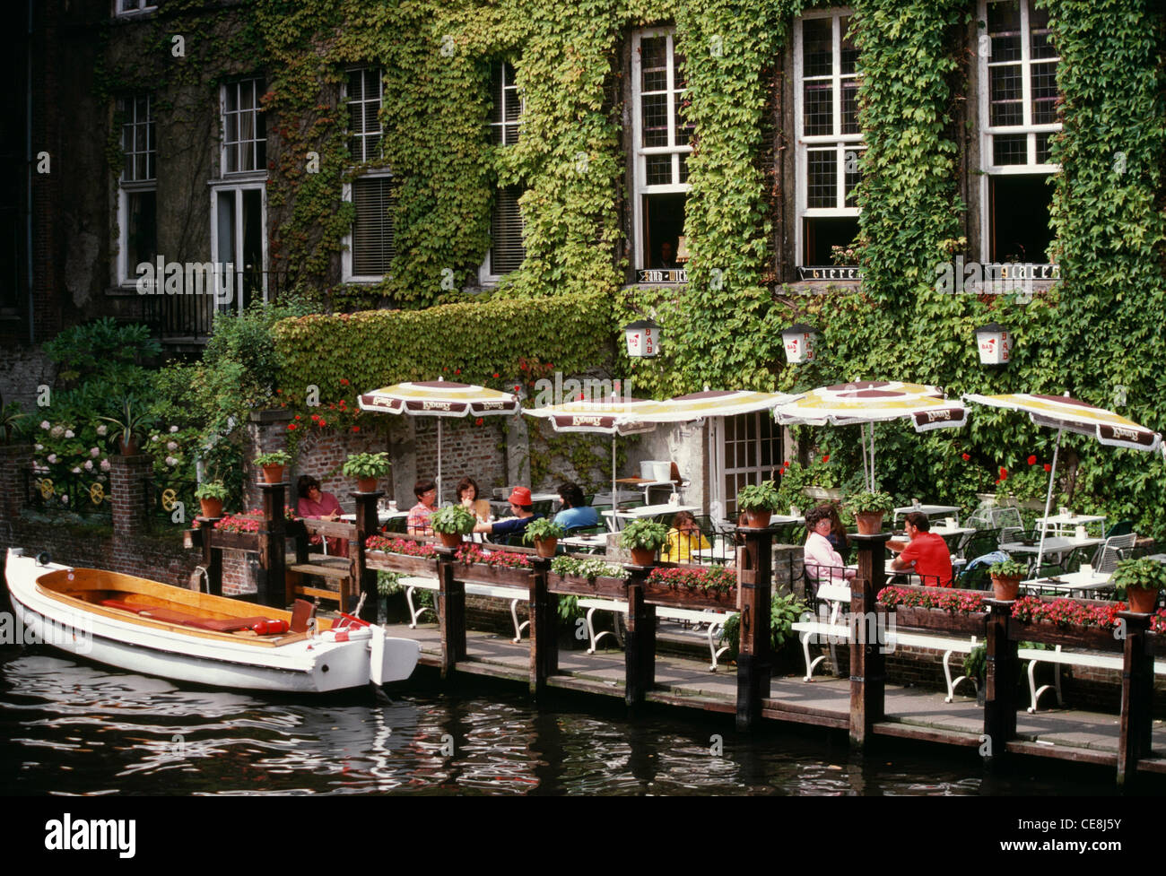 Restaurant and boat on a Canal, Bruges, Belgium Stock Photo - Alamy