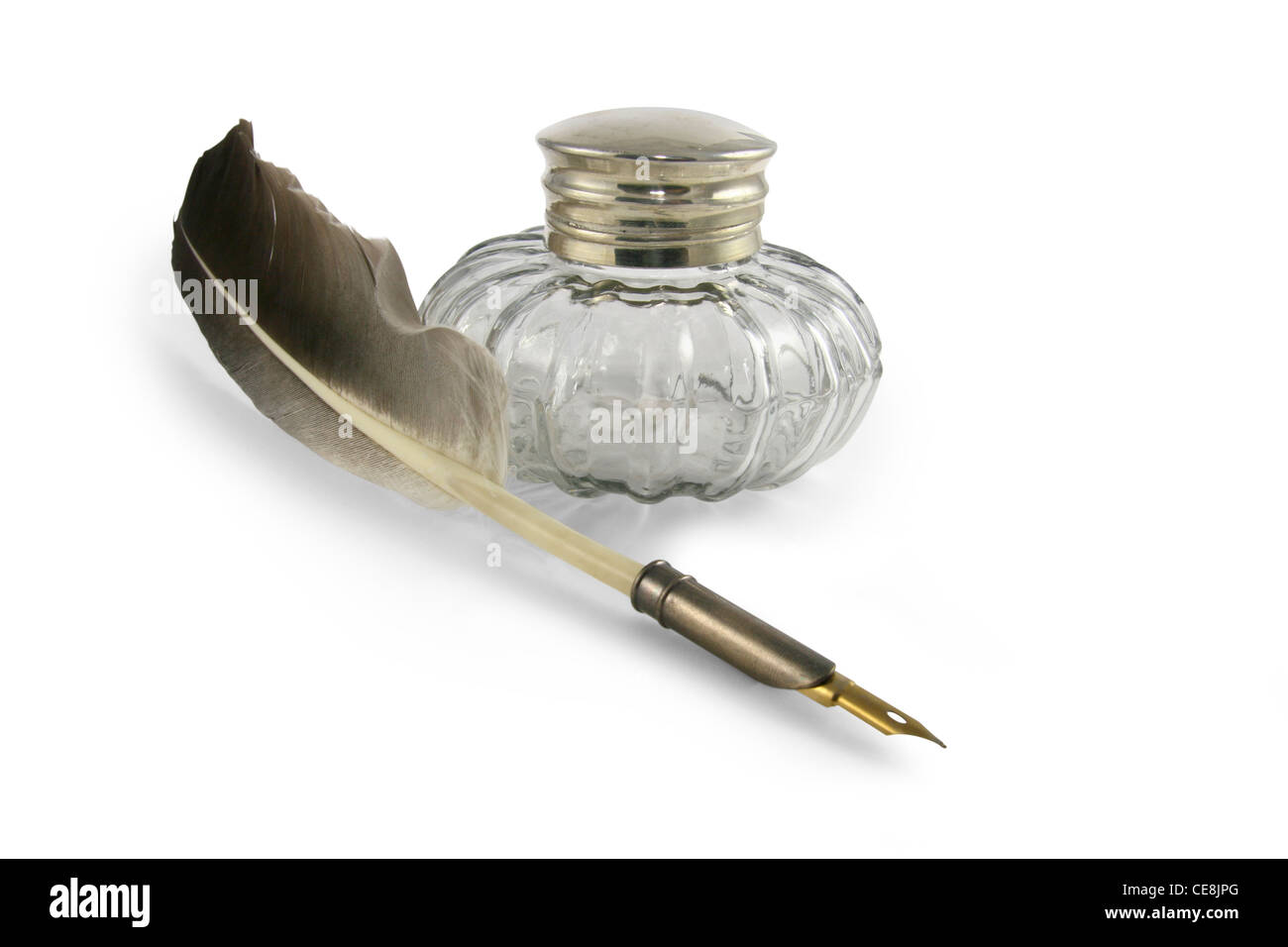 Feather quill pen in a circa 1890s to 1940s style glass inkwell Stock