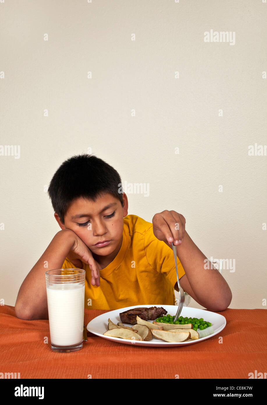 10-11 year old Hispanic boy doesn't want to eat. MR  © Myrleen Pearson Stock Photo