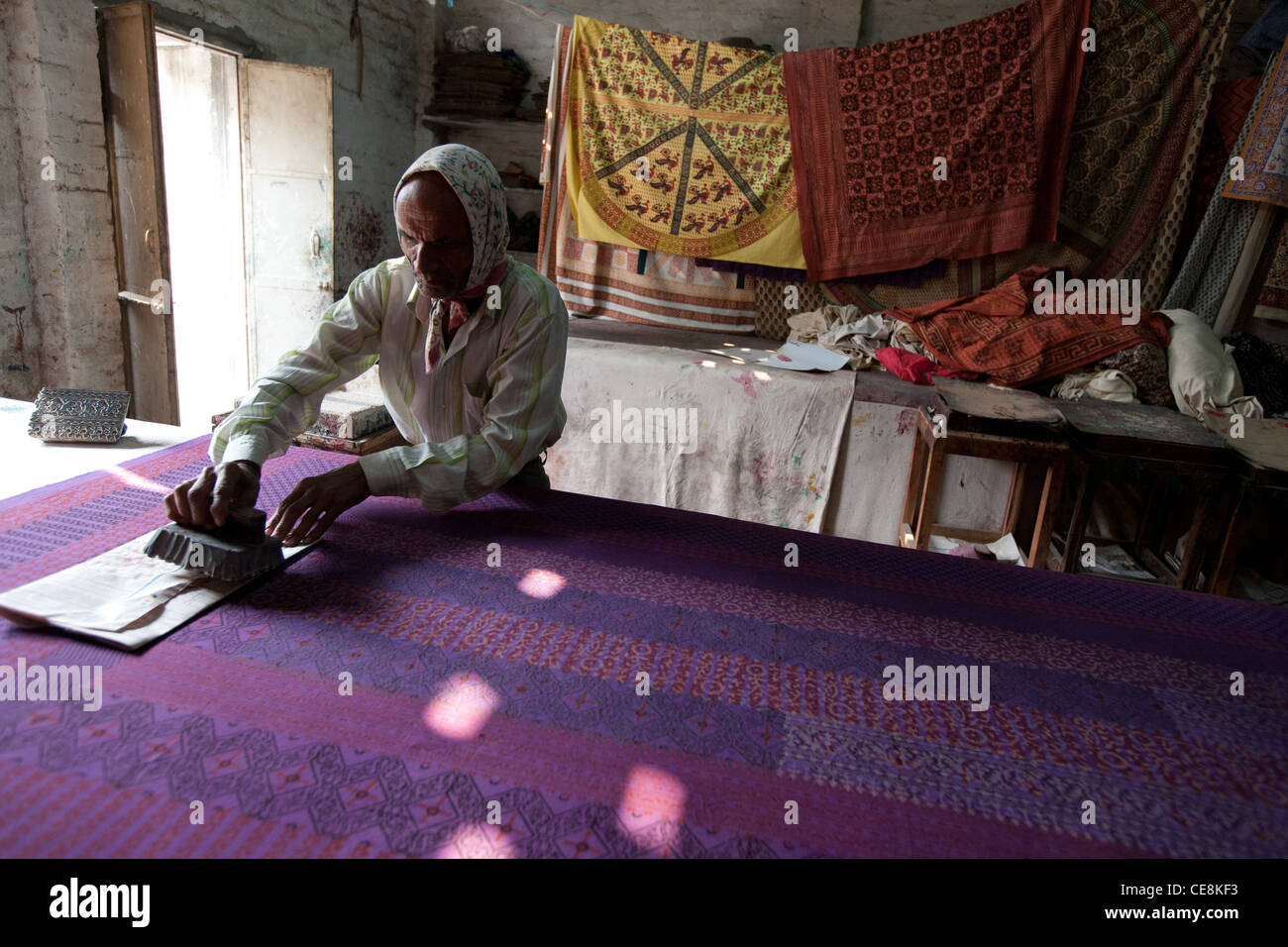 Wood block printing dyes onto textiles at a small factory in Sanganer