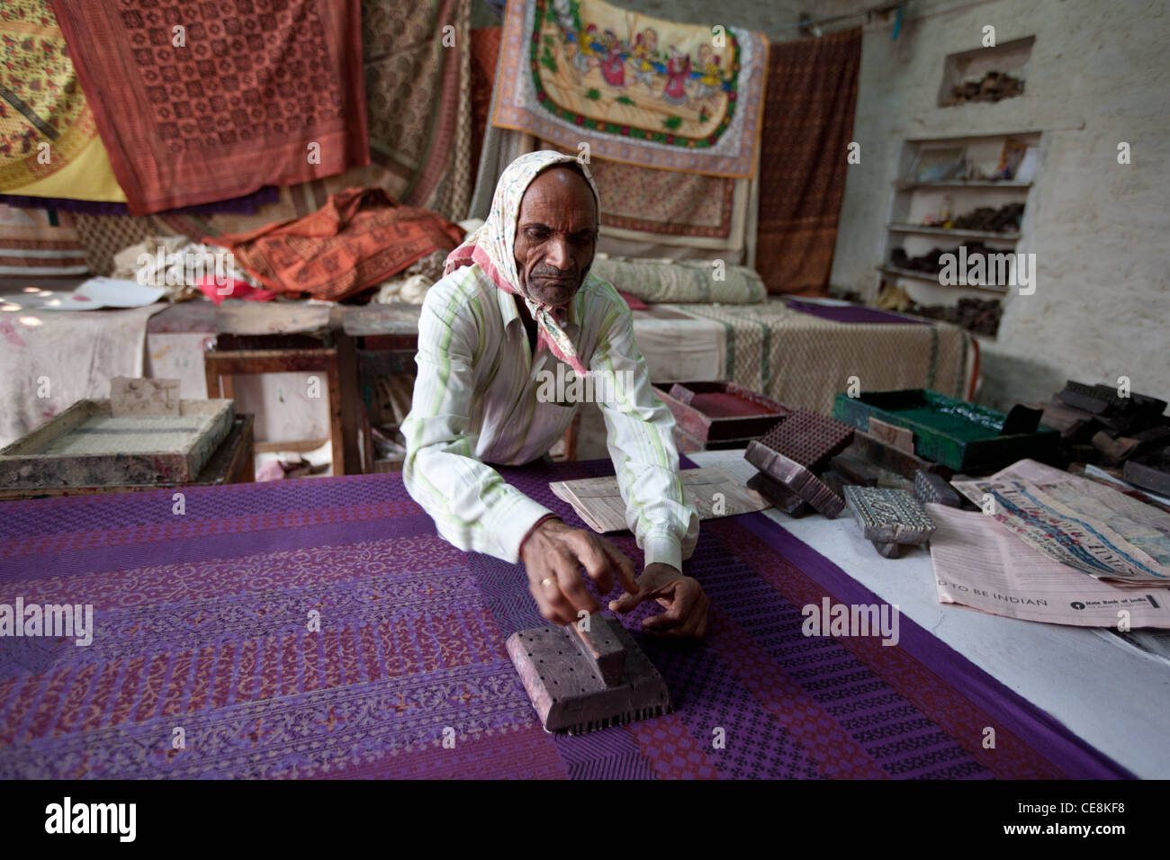 Wood block printing dyes onto textiles at a small factory in Sanganer