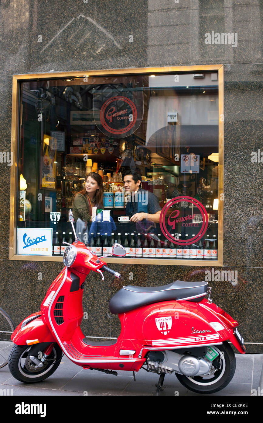 Couple sitting in window of cafe, talking and drinking coffee. Melbourne, Victoria, Australia Stock Photo