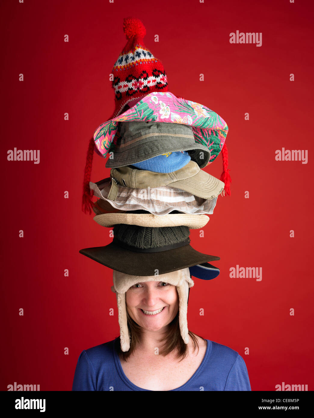 Woman wearing many hats Stock Photo - Alamy