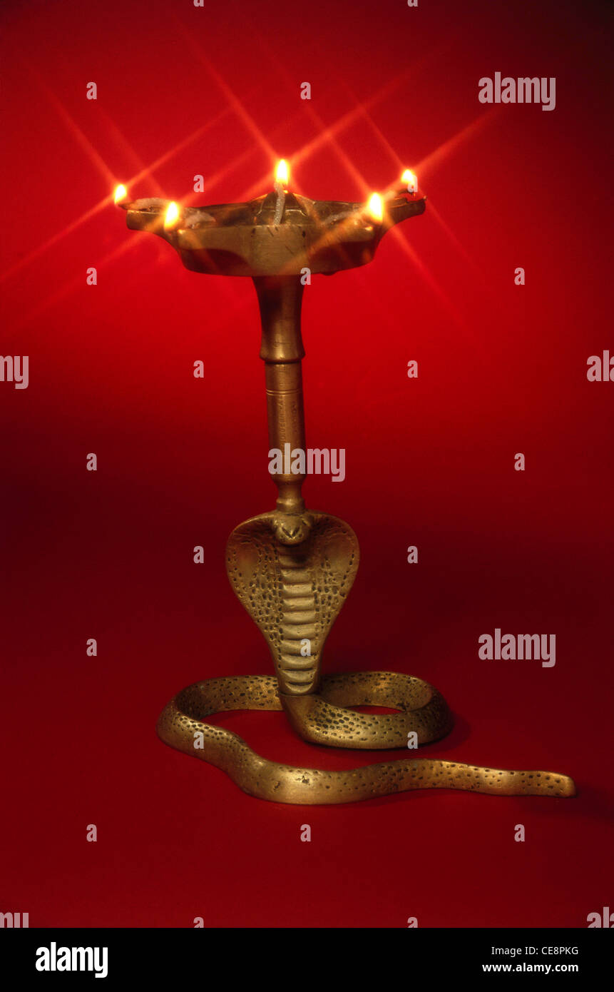 MPC 81280 : Brass Oil Lamp on cobra snake on red background Stock Photo