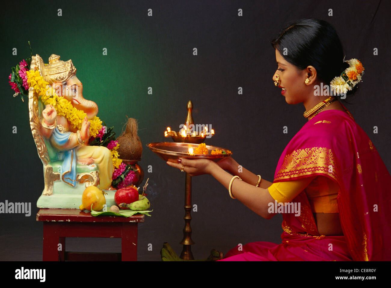 RHS 81392 indian woman performing pooja puja of lord Ganesh ganpati