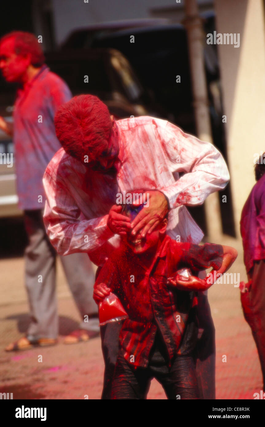 HMA 81490 : father and son playing with colour ; holi festival ; india Stock Photo