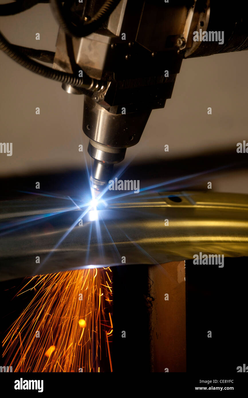 A laser cutting a metal sheet in a factory in Coventry, United Kingdom. Stock Photo