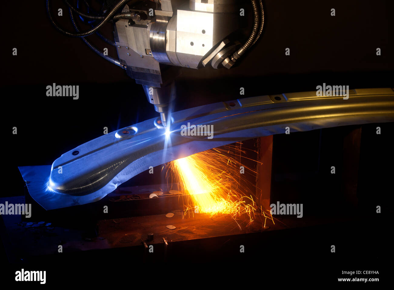 A laser cutting a metal sheet in a factory in Coventry, United Kingdom. Stock Photo