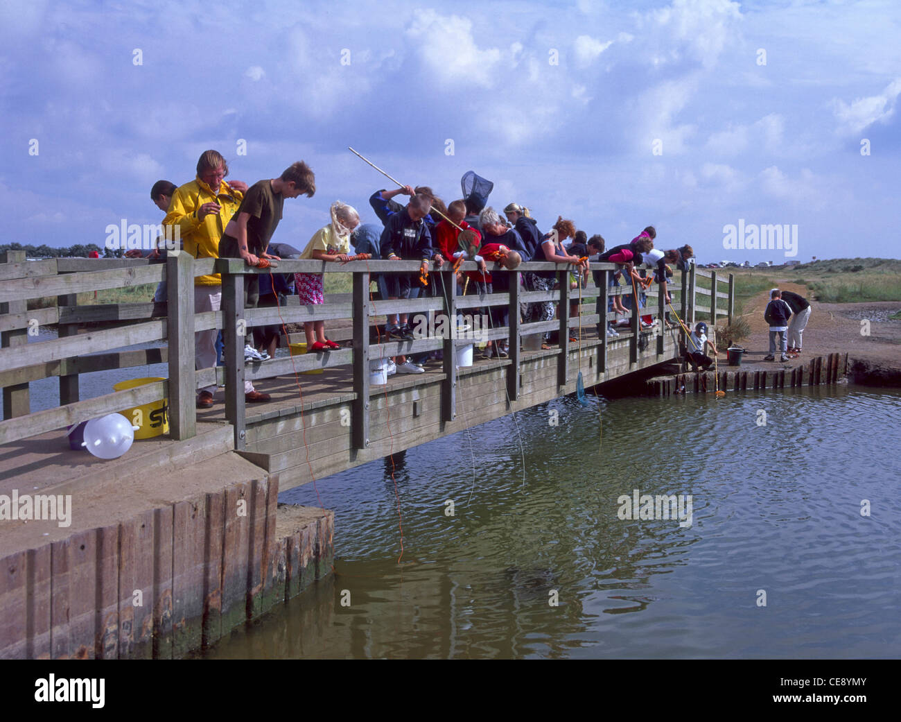 https://c8.alamy.com/comp/CE8YMY/rods-hooks-fishing-nets-in-use-children-playing-catching-crab-at-popular-CE8YMY.jpg