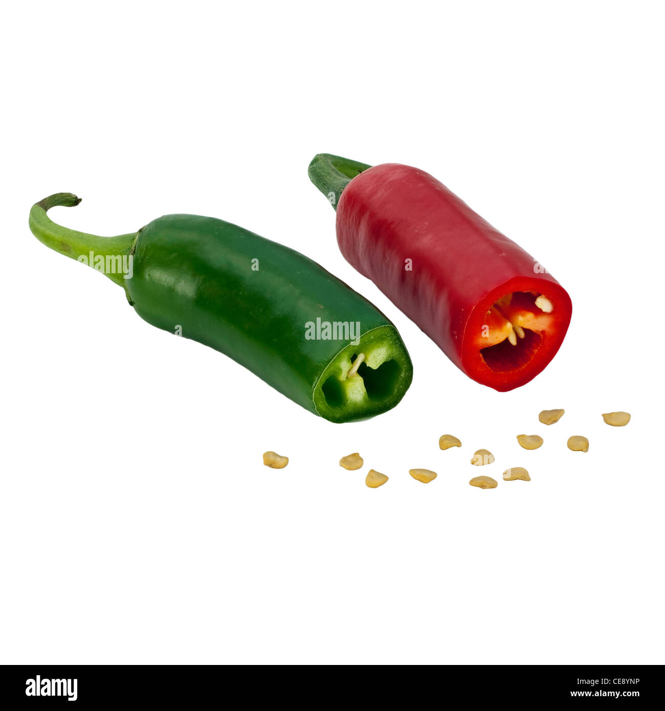 One red and one green chile sliced with seeds in front Stock Photo