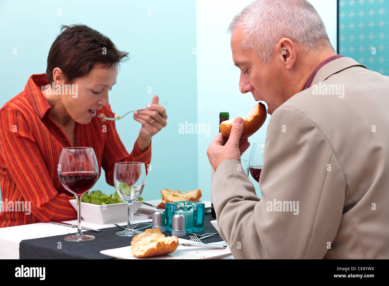 Photo of a mature married couple eating a meal in a restaurant. Stock Photo